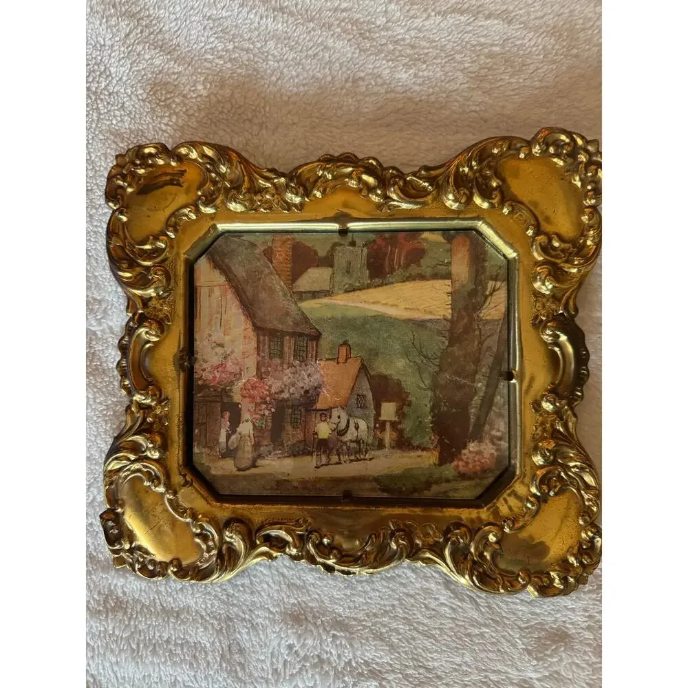 Vintage embossed brass frame with a foil print of an English countryside.